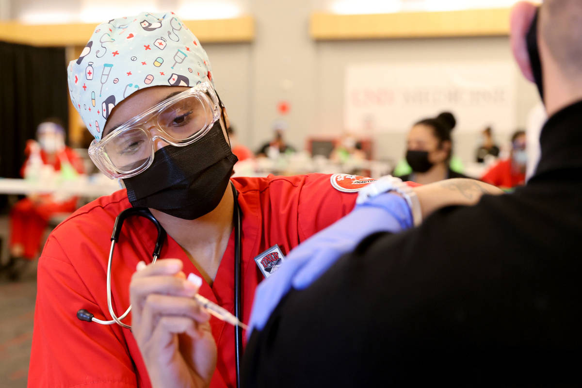 Nursing student Alaysia Robinson gives a COVID-19 vaccine during a UNLV Medicine clinic in the ...