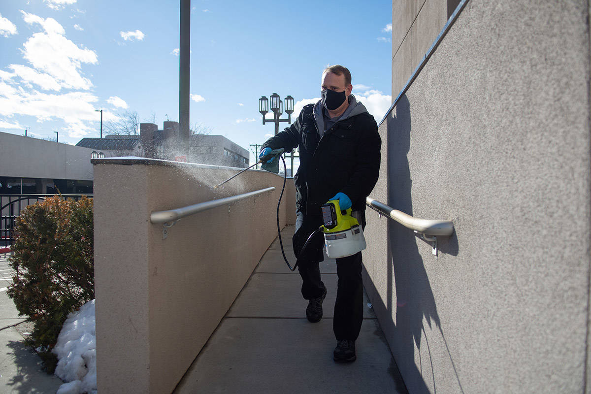 A legislative employee sanitizes a hand rail outside the building on the first day of the 81st ...