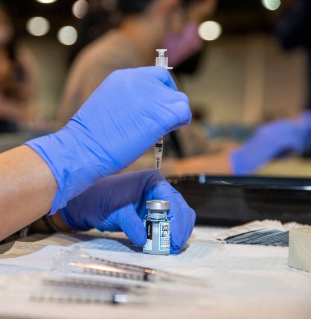 RN Dawn Schuder prepares another dose of the Moderna vaccine at the Southern Nevada Health Dist ...