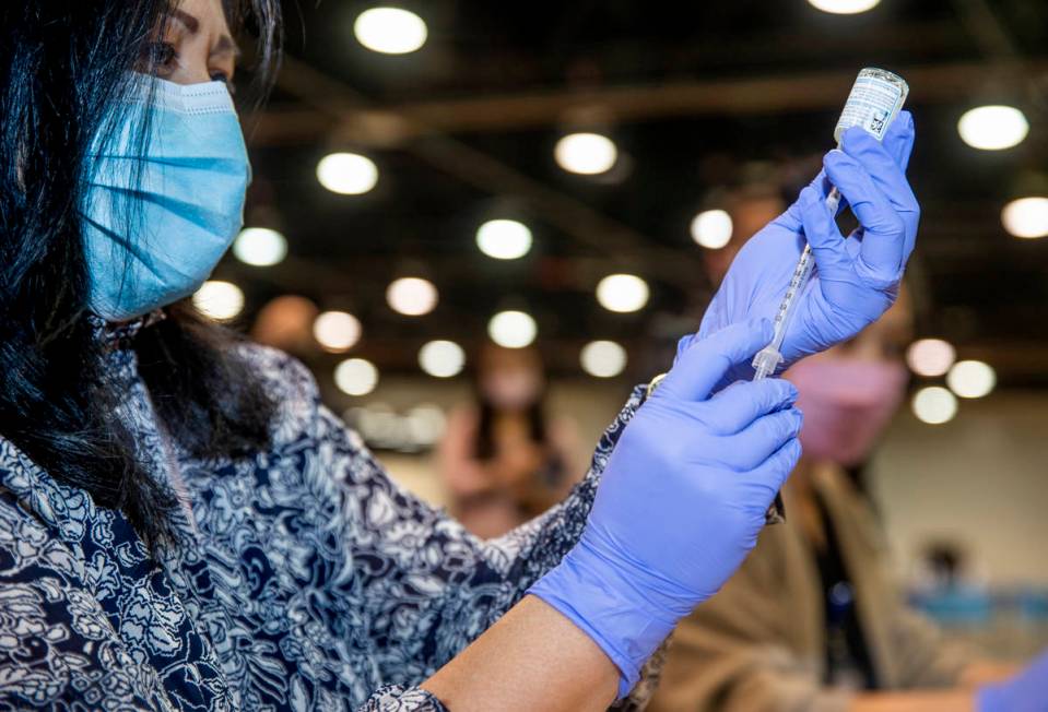 RN Dawn Schuder prepares another dose of the Moderna vaccine at the Southern Nevada Health Dist ...