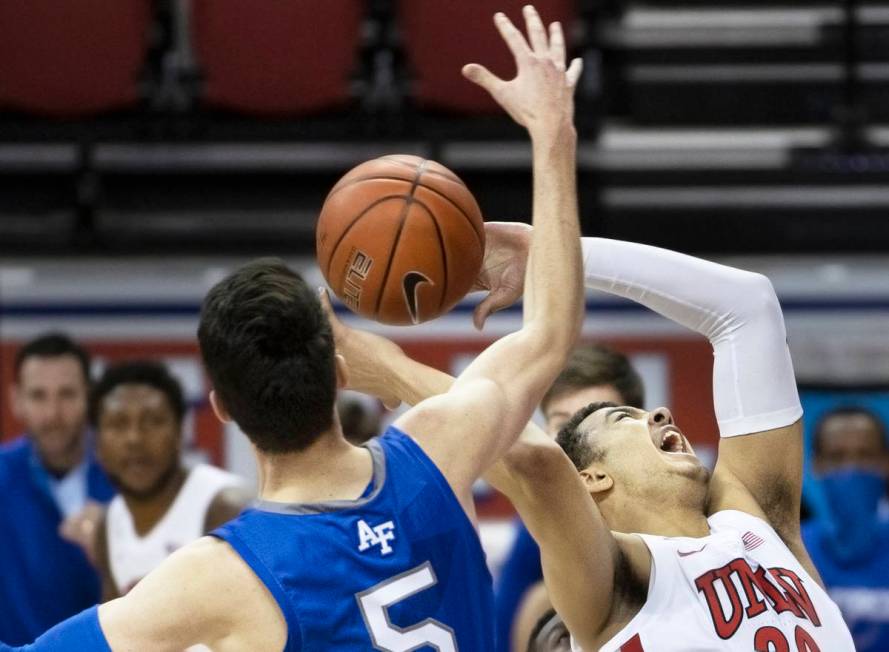 UNLV Rebels forward Devin Tillis (30) slices to the rim past Air Force Falcons guard Chris Joyc ...