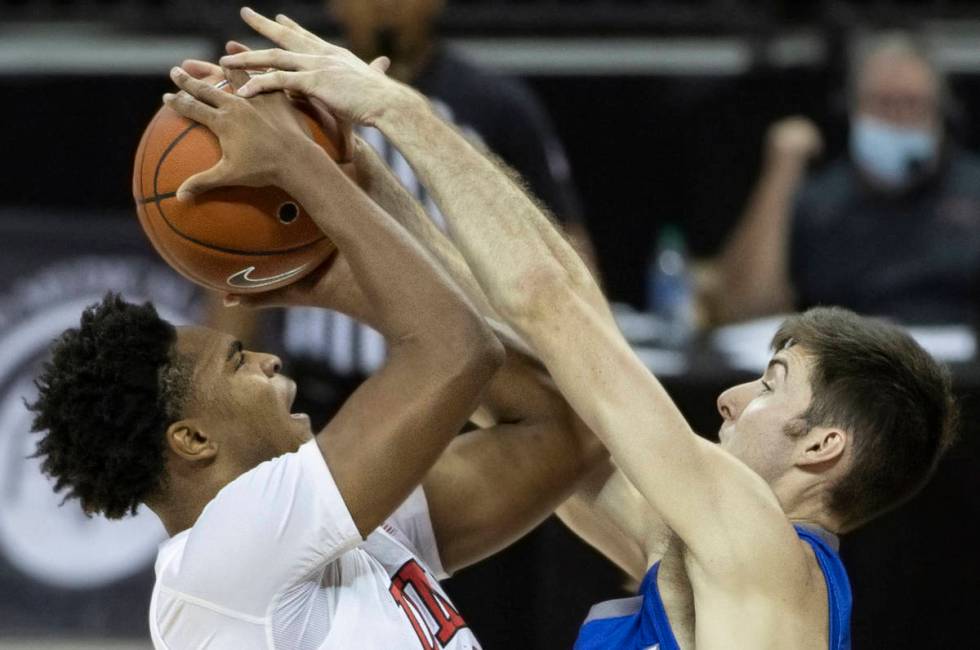 UNLV Rebels guard Bryce Hamilton (13) takes a contested shot over Air Force Falcons guard Mason ...