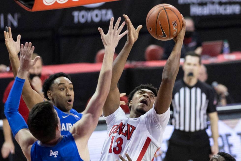 UNLV Rebels guard Bryce Hamilton (13) slices to the rim past Air Force Falcons guard Chris Joyc ...