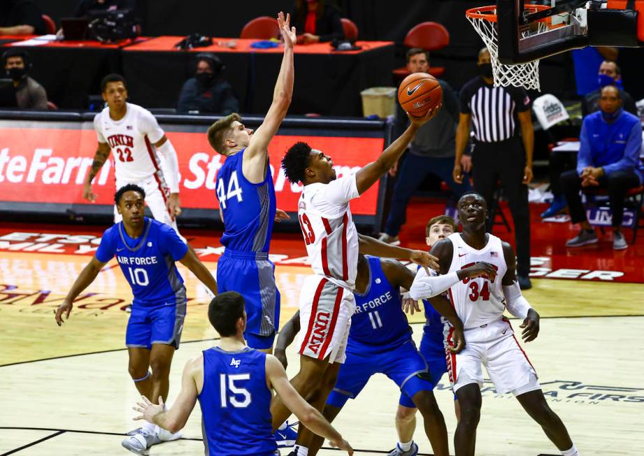 UNLV Rebels guard Bryce Hamilton (13) goes to the basket under pressure from Air Force Falcons ...