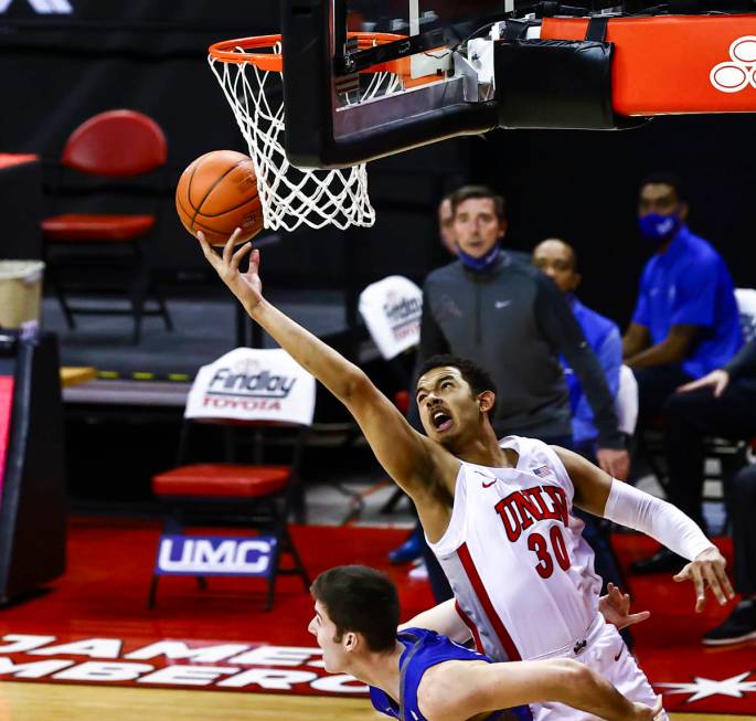 UNLV Rebels forward Devin Tillis (30) reaches for a rebound during the first half of a basketba ...