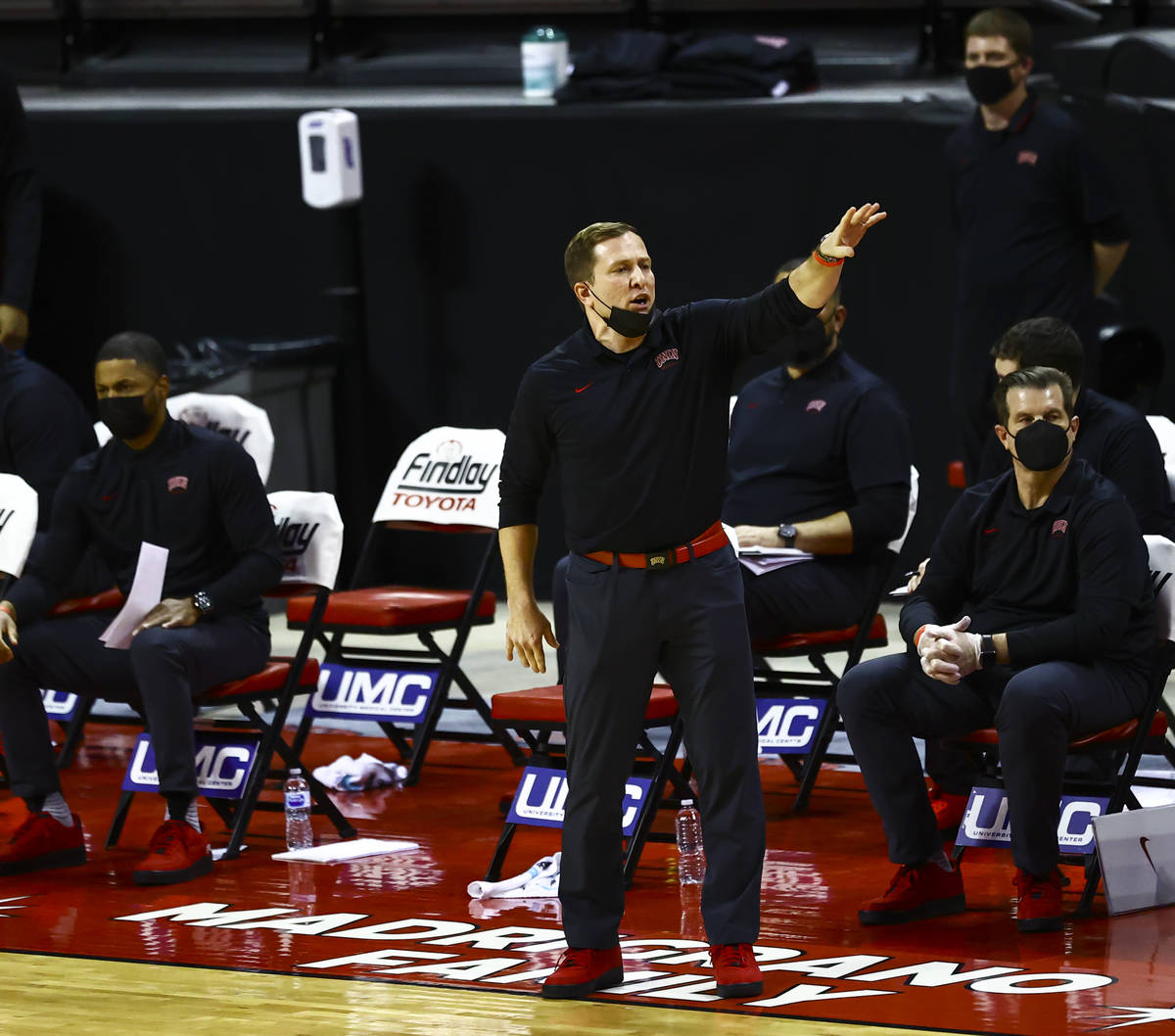 UNLV Rebels head coach T.J. Otzelberger motions to his team during the first half of a basketba ...