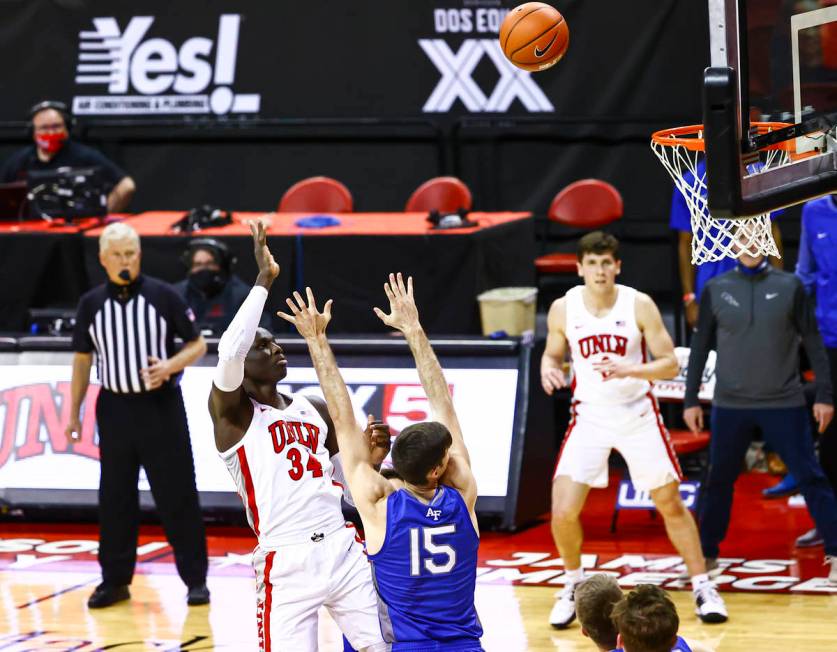 UNLV Rebels forward Cheikh Mbacke Diong (34) shoots over Air Force Falcons forward Abe Kinrade ...