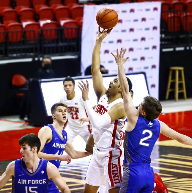 UNLV Rebels forward Devin Tillis shoots under pressure from Air Force Falcons guard Glen McClin ...