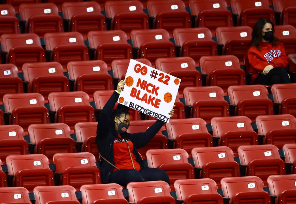 A UNLV fan cheers and holds up a sign for Rebels guard Nick Blake (22) during the second half o ...