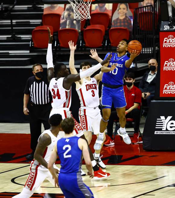 Air Force Falcons guard A.J. Walker (10) shoots under pressure from UNLV Rebels forward Cheikh ...