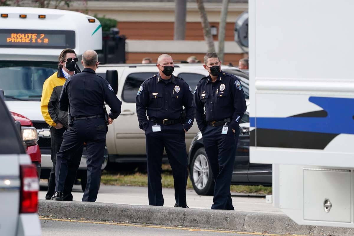 Law enforcement officers block an area where a shooting wounded several FBI agents while servin ...