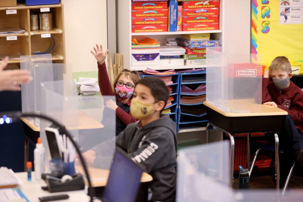 First grade students, from left, Cora Reardon, 6, Vincent Morales 6, Logan Breen, 7, attend in ...