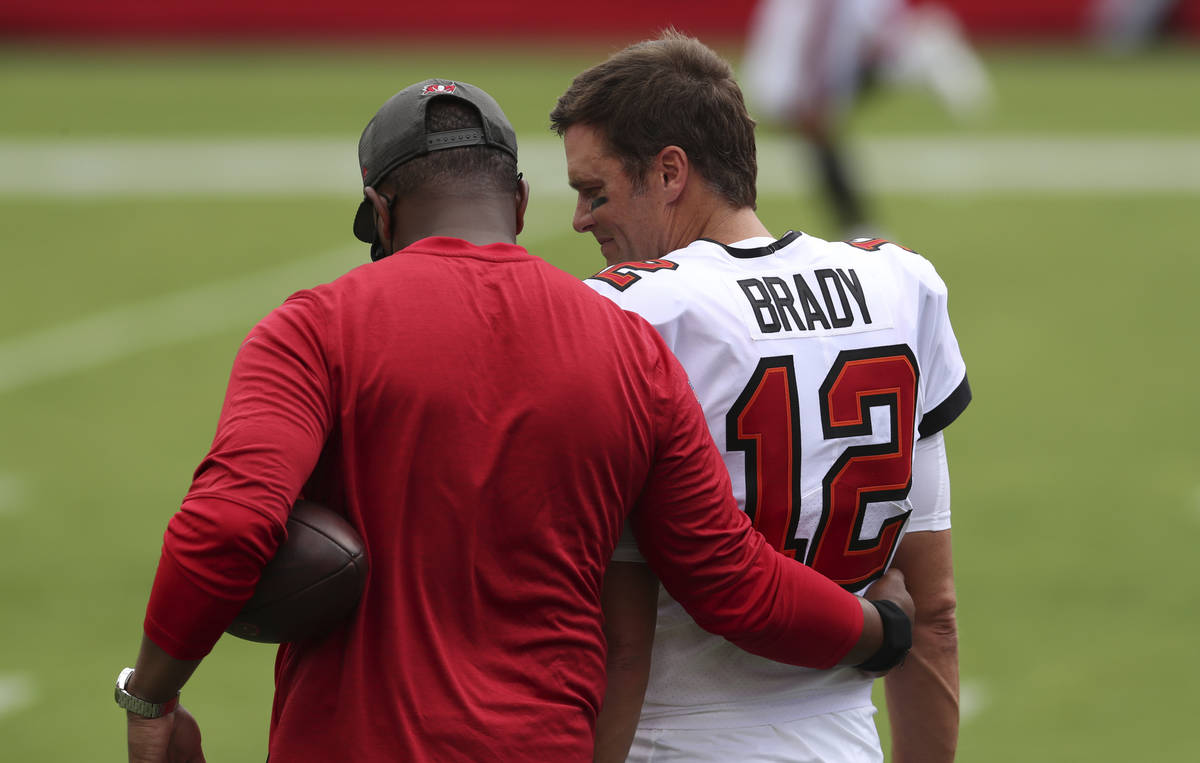 Tampa Bay Buccaneers quarterback Tom Brady (12) talks to offensive coordinator Byron Leftwich b ...