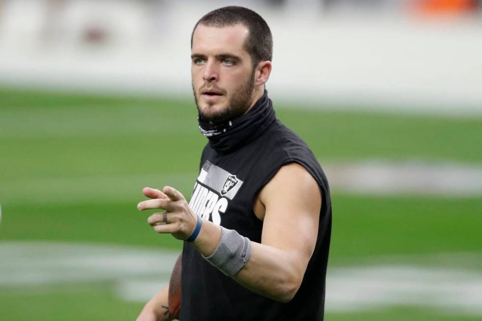 Las Vegas Raiders quarterback Derek Carr (4) warms up before an NFL football game against the I ...