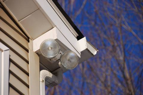 Floodlights attached to house corner to provide security and lighting to the driveway below. (G ...