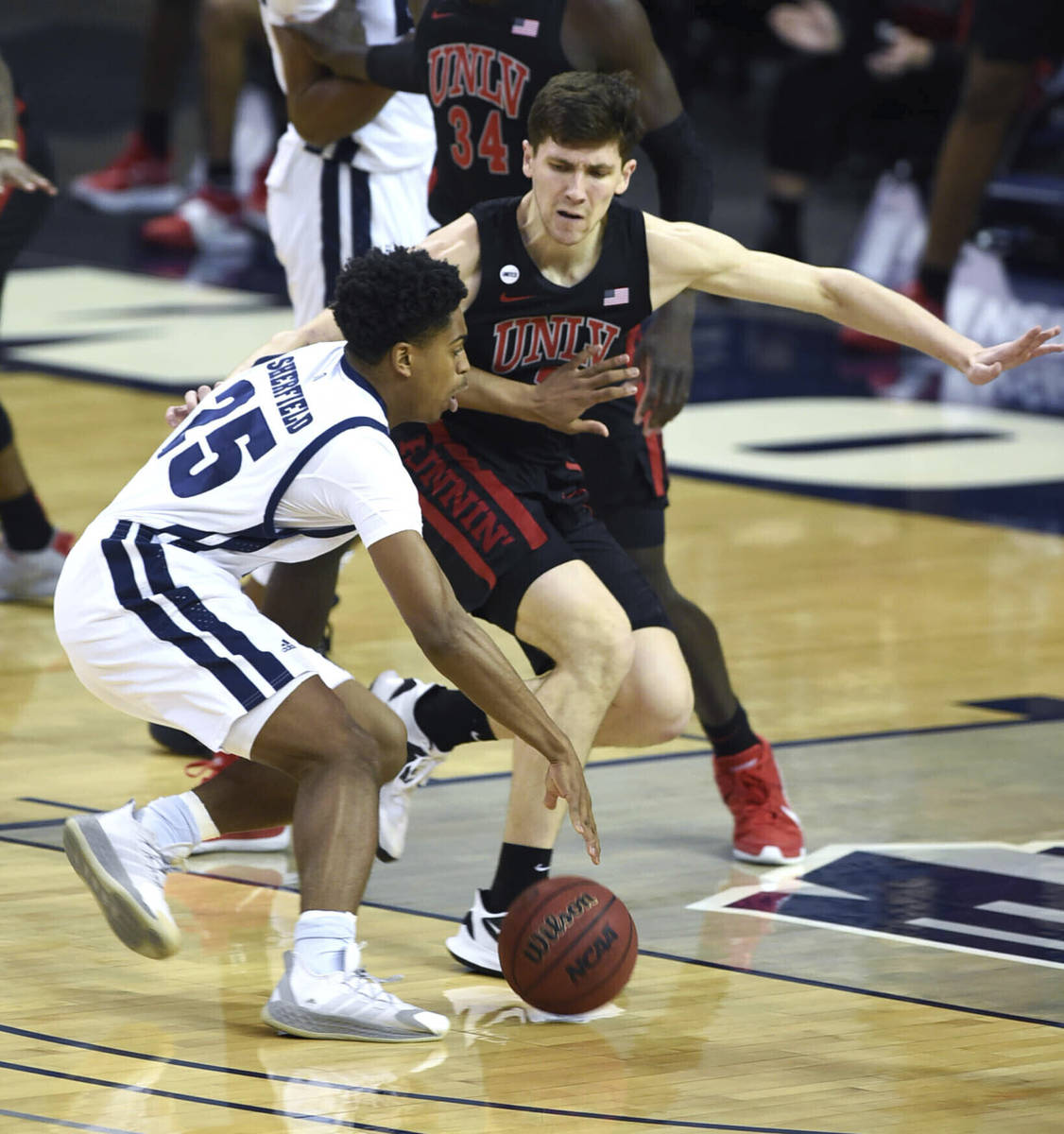 Nevada's Grant Sherfield dribbles the ball against UNLV during the first half of an NCAA colleg ...