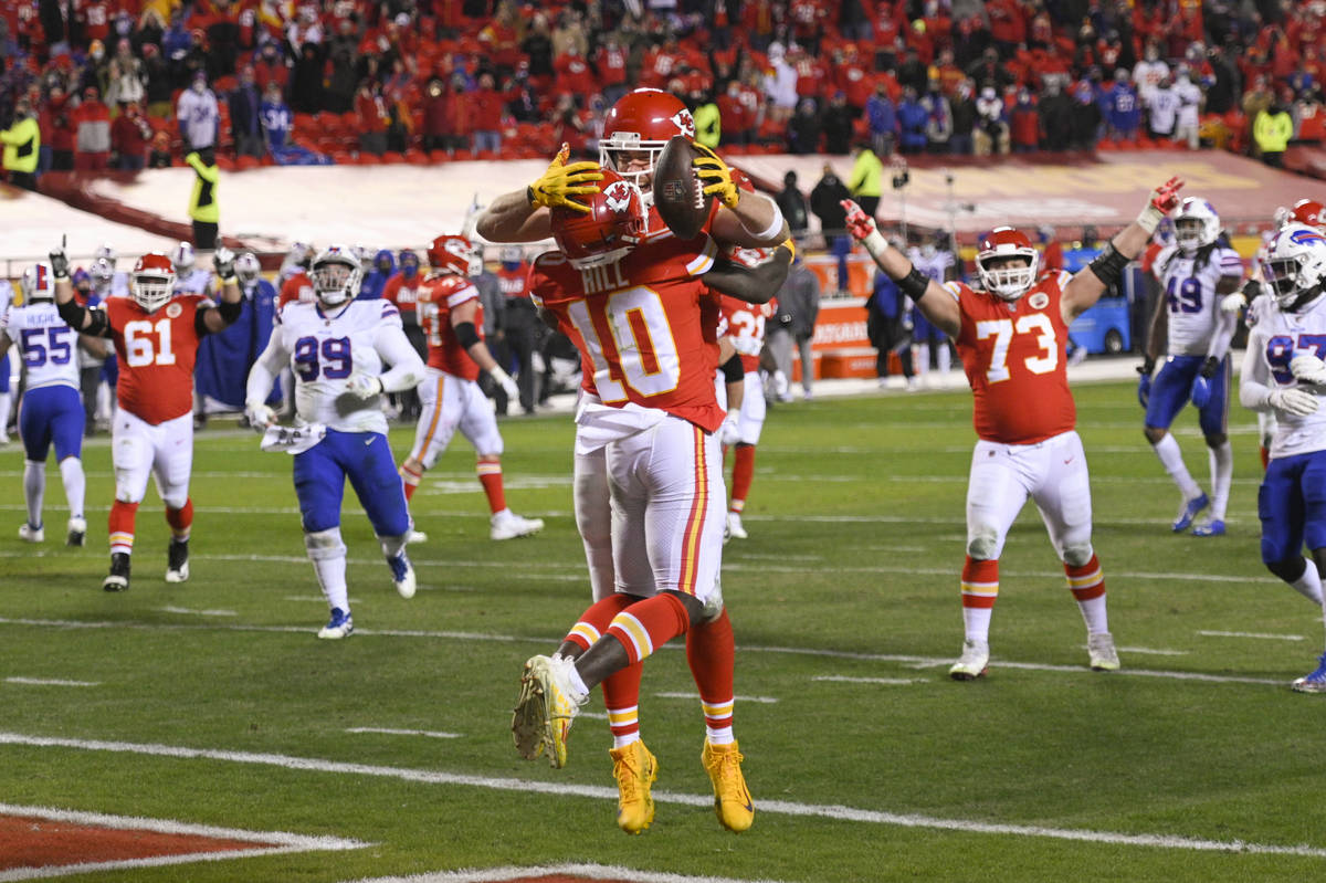 Kansas City Chiefs tight end Travis Kelce (with ball) and teammate wide receiver Tyreek Hill (1 ...