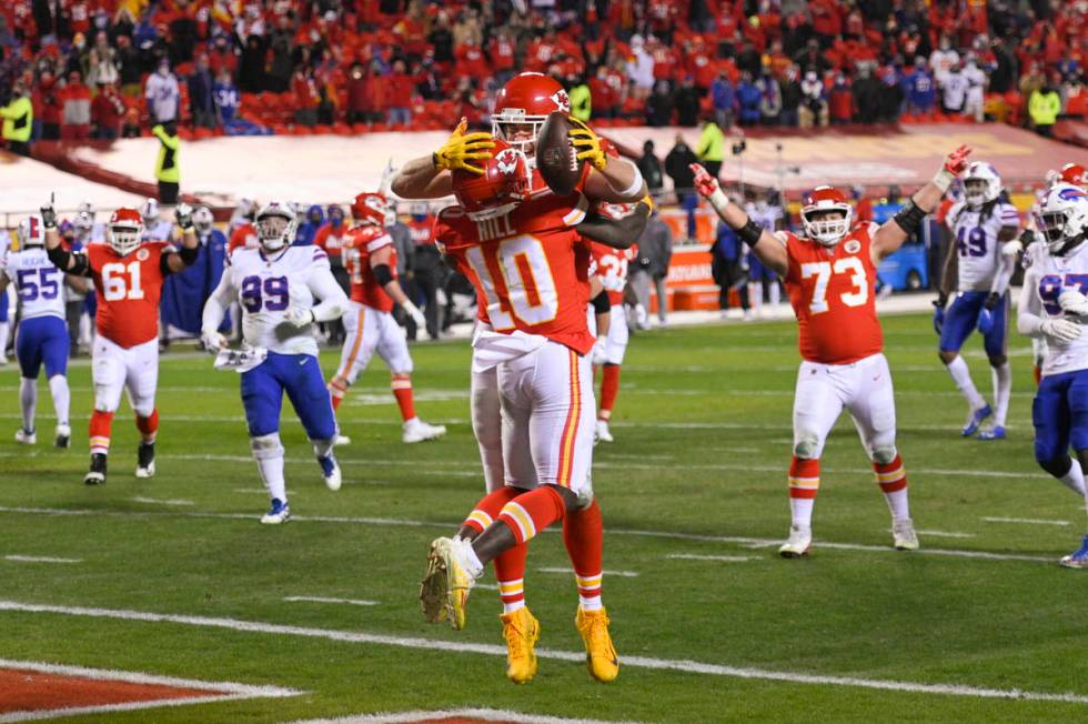 Kansas City Chiefs tight end Travis Kelce (with ball) and teammate wide receiver Tyreek Hill (1 ...