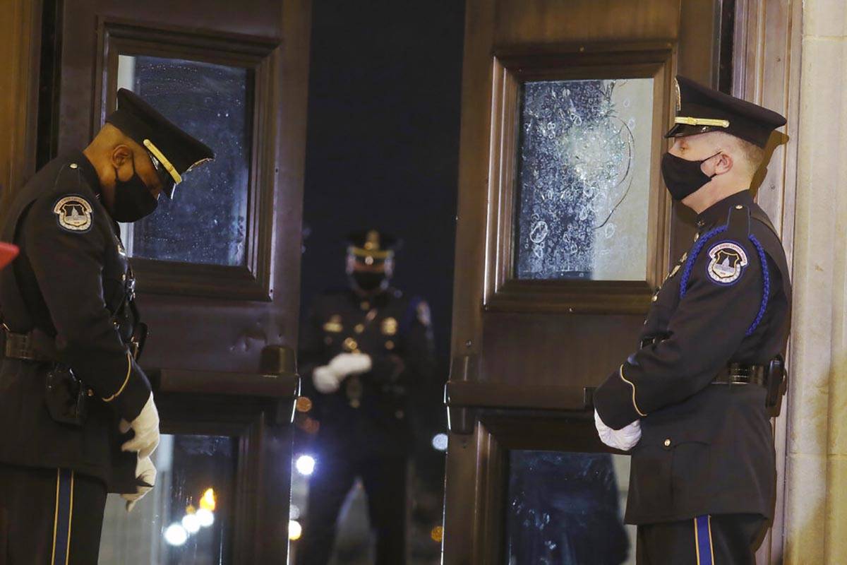 U.S. Capitol Police officers stand guard near the doors of the Capitol Rotunda where the late U ...