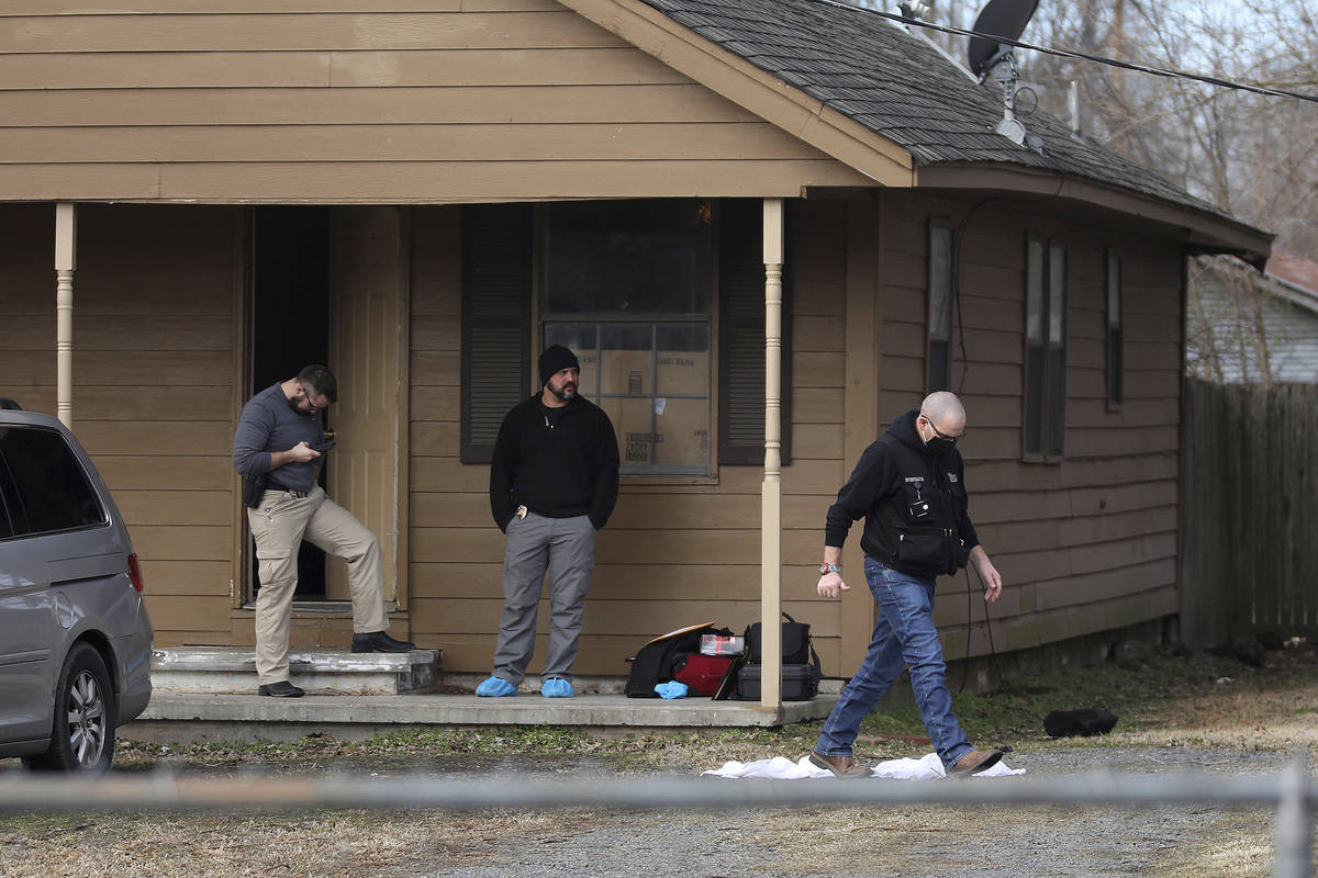 Investigators work at the scene of a shooting on Tuesday, Feb. 2, 2021 in Muskogee, Okla. Polic ...