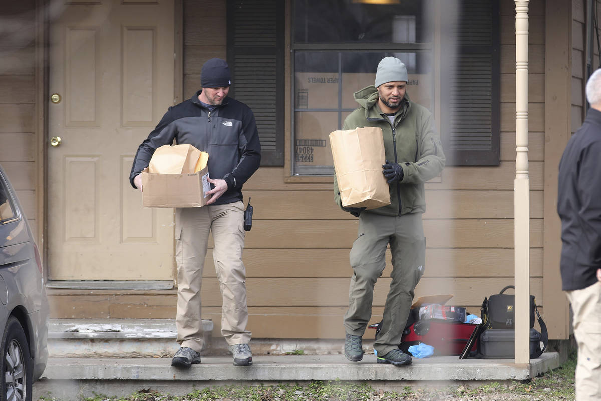 Investigators remove items from the scene of a shooting on Tuesday, Feb. 2, 2021 in Muskogee, O ...