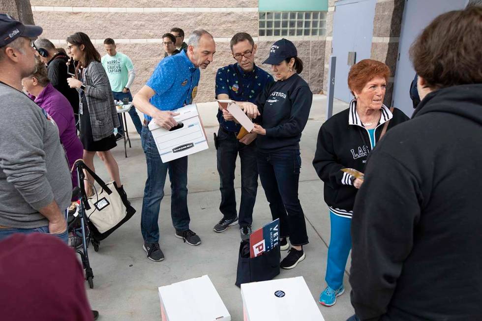 Pete Buttigieg supporters converse before the Nevada caucus begins at Palo Verde High School on ...