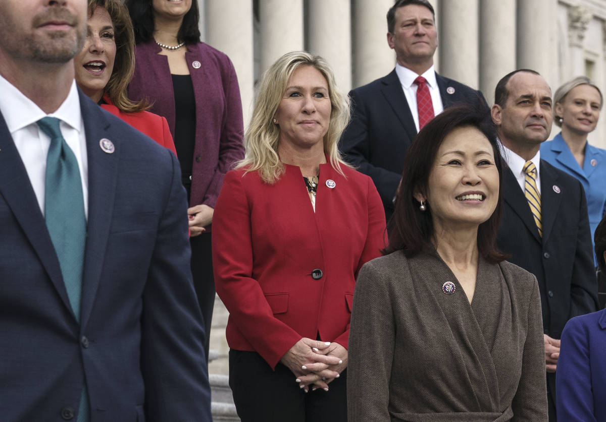 In this Jan. 4, 2021, photo, Rep. Marjorie Taylor Greene, R-Ga., center, stands with other GOP ...