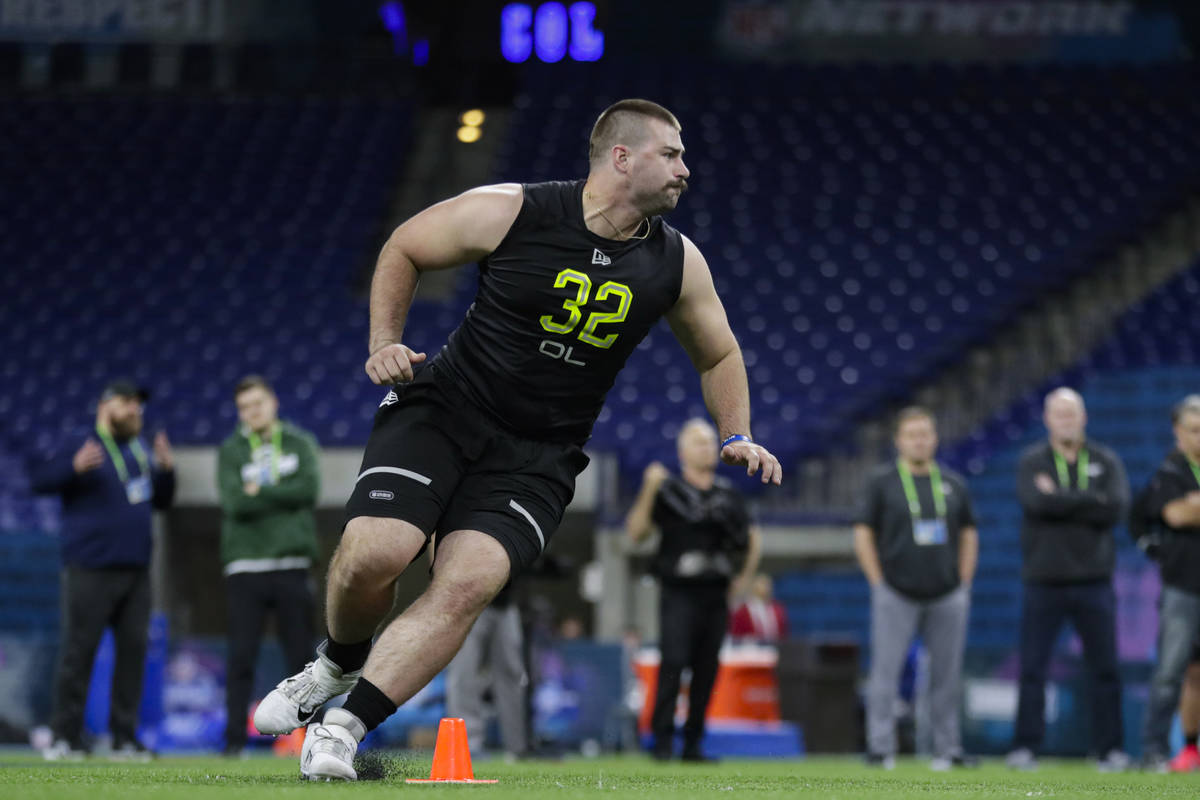 Boise State offensive lineman John Molchon runs a drill at the NFL football scouting combine in ...