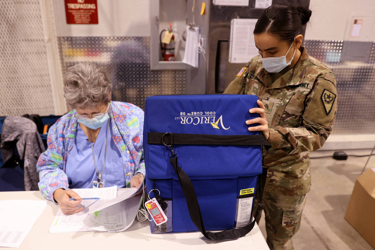 Nevada National Guard Sgt. Candy "D.T." Delatorre retrieves Pfizer vaccine from a coo ...