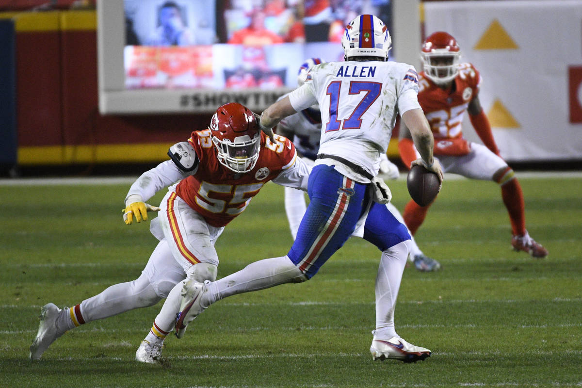 Buffalo Bills quarterback Josh Allen (17) tries to evade Frank Clark (55) during the second hal ...