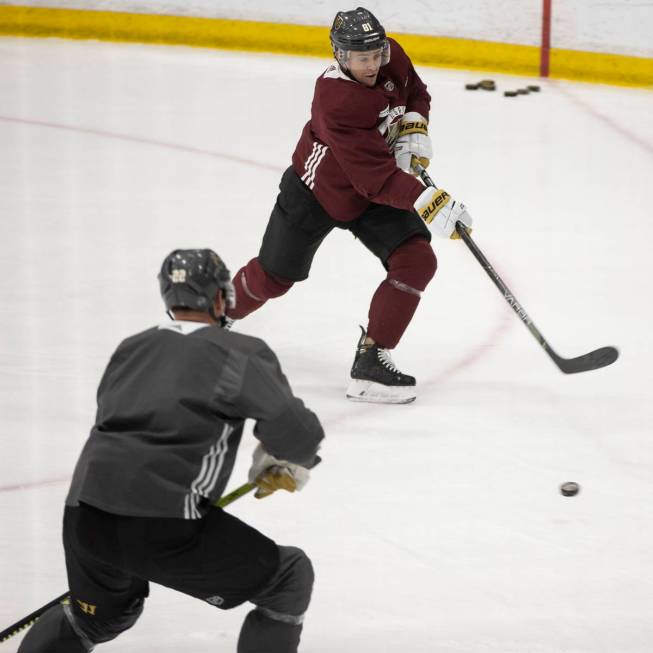 Vegas Golden Knights center Jonathan Marchessault (81) takes a shot under pressure from Nick Ho ...