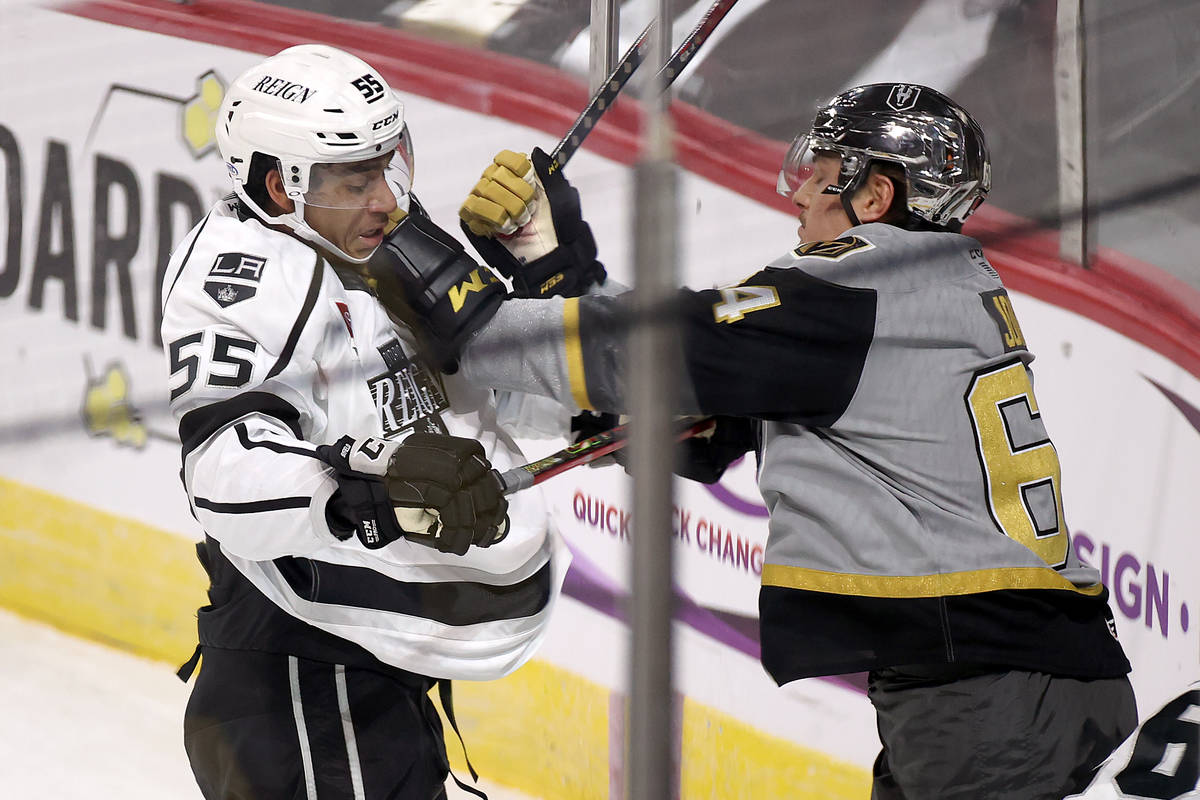 Henderson Silver Knights forward Ben Jones (64) protects the puck from Ontario Reign Quinton By ...