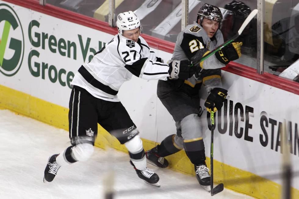 Ontario Reign Tyler Madden (27) slams Henderson Silver Knights forward Danny O'Regan (21) again ...