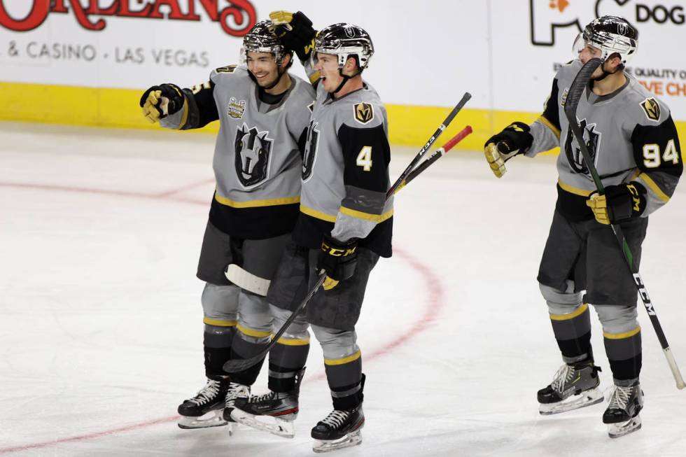 Henderson Silver Knights forward Dylan Sikura (15) celebrates his goal with defenseman Jimmy Sc ...