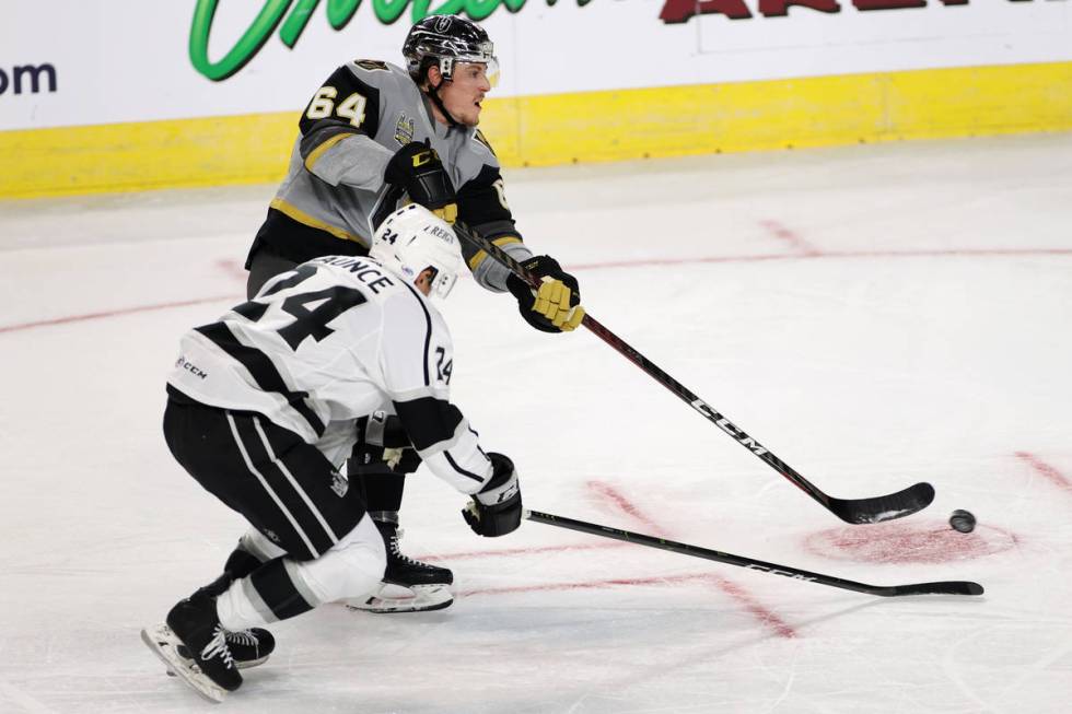 Henderson Silver Knights forward Ben Jones (64) takes a shot at the goal under pressure from On ...