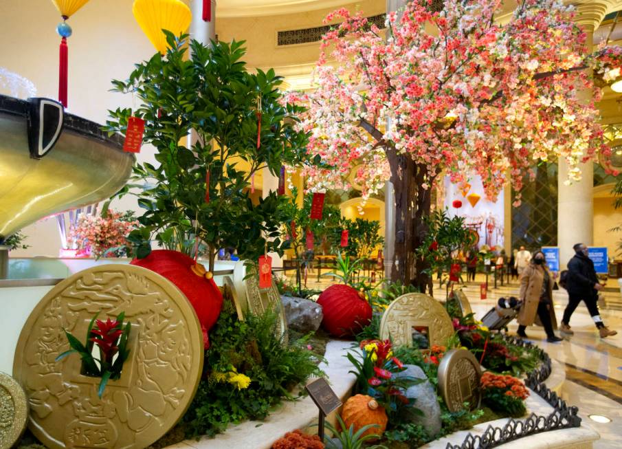 Visitors walk past a Wishing Tree art installation for the Lunar New Year at the Grand Canal Sh ...