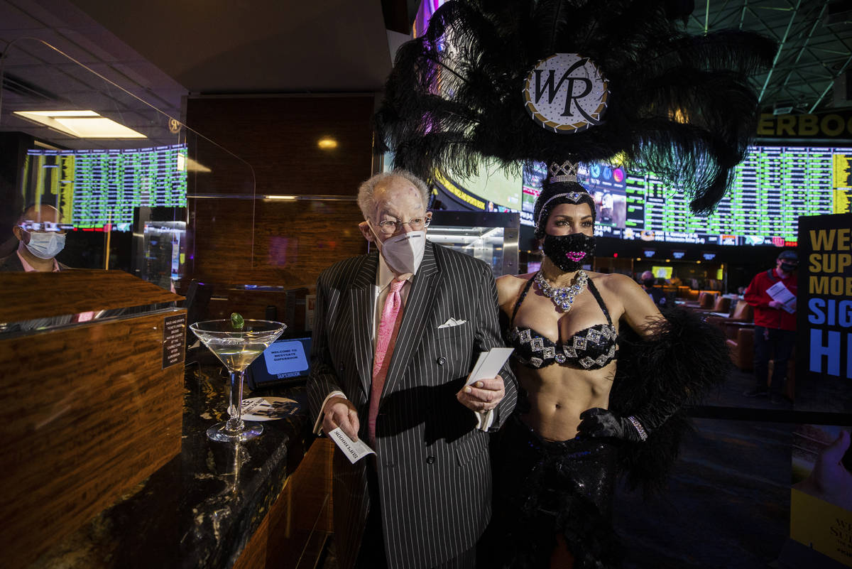 Former Las Vegas Mayor Oscar Goodman, left, is escorted by a showgirl after placing his Super B ...