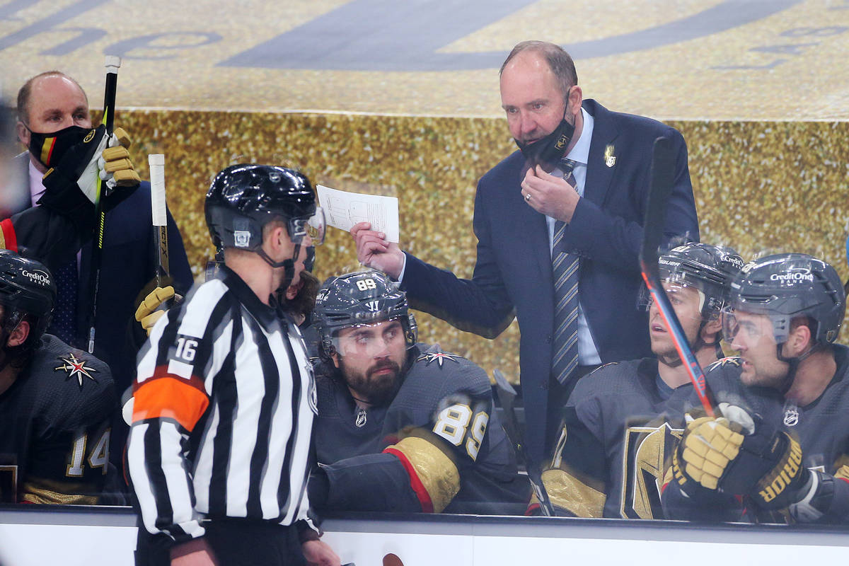 Vegas Golden Knights head coach Peter DeBoer, center, speaks to an official during the second p ...