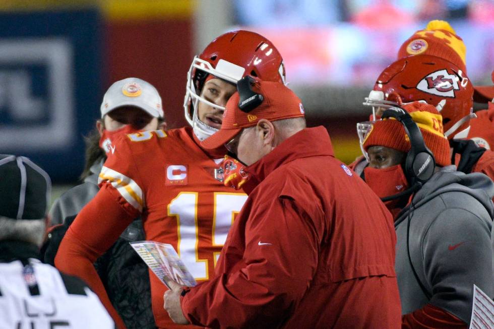 Kansas City Chiefs quarterback Patrick Mahomes talks with head coach Andy Reid during the first ...