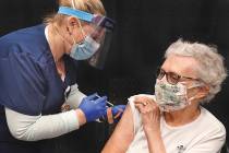 Yuma Regional Medical Center registered nurse Candace Manville, left, administers a COVID-19 va ...