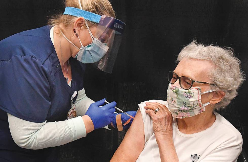 Yuma Regional Medical Center registered nurse Candace Manville, left, administers a COVID-19 va ...