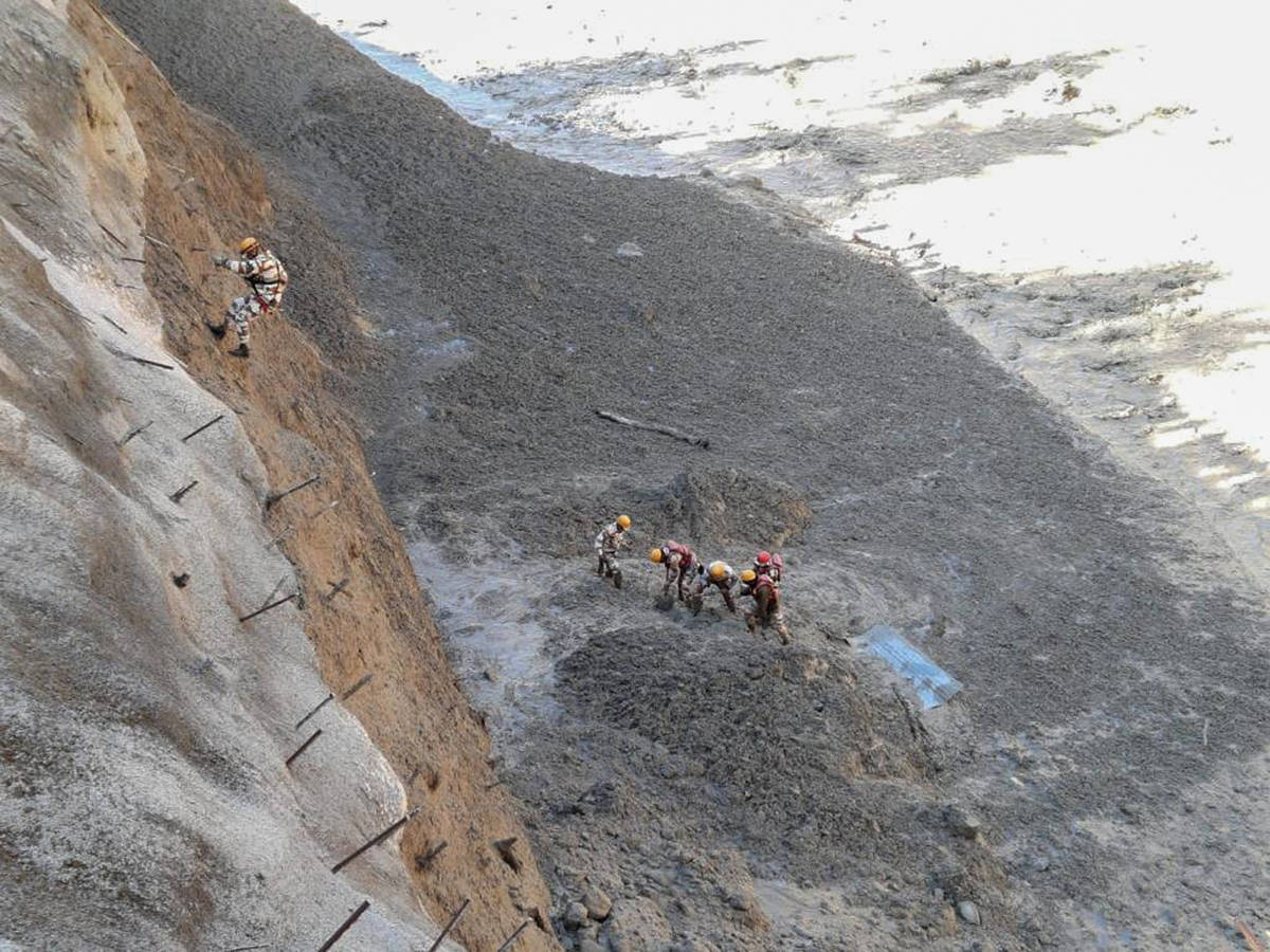 This photograph provided by Indo Tibetan Border Police (ITBP) shows ITBP personnel begin rescue ...