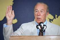 FILE--Secretary of State George Shultz gestures during a news conference at the State Departmen ...