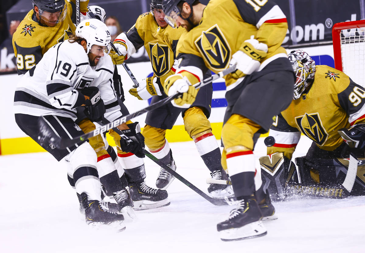 Los Angeles Kings right wing Alex Iafallo (19) attempts to get the puck past Golden Knights def ...