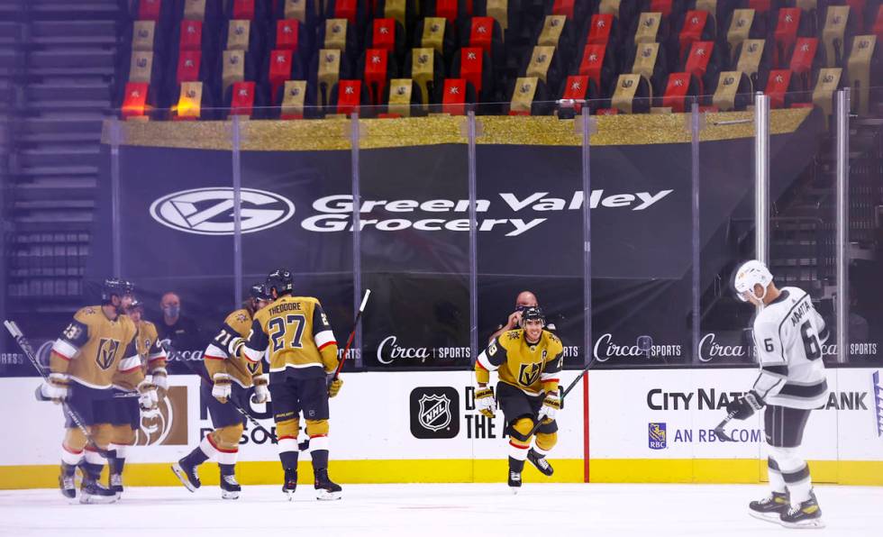 Golden Knights right wing Reilly Smith (19) skates to celebrate with the bench after his goal a ...