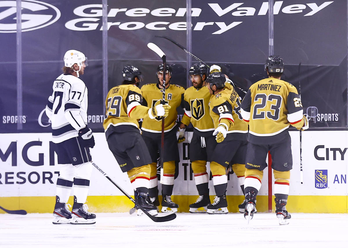 Golden Knights center Chandler Stephenson, fourth from left, celebrates his second goal of the ...