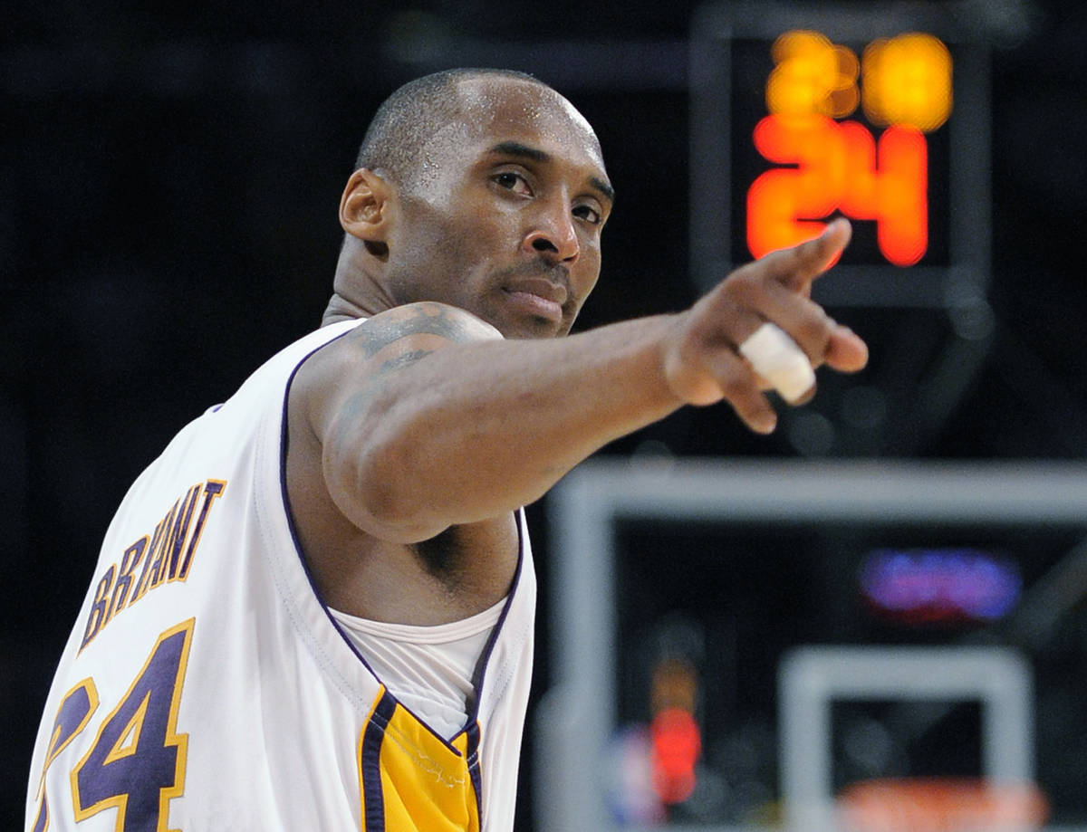 FILE - In this June 7, 2009, file photo, Los Angeles Lakers guard Kobe Bryant (24) points to a ...