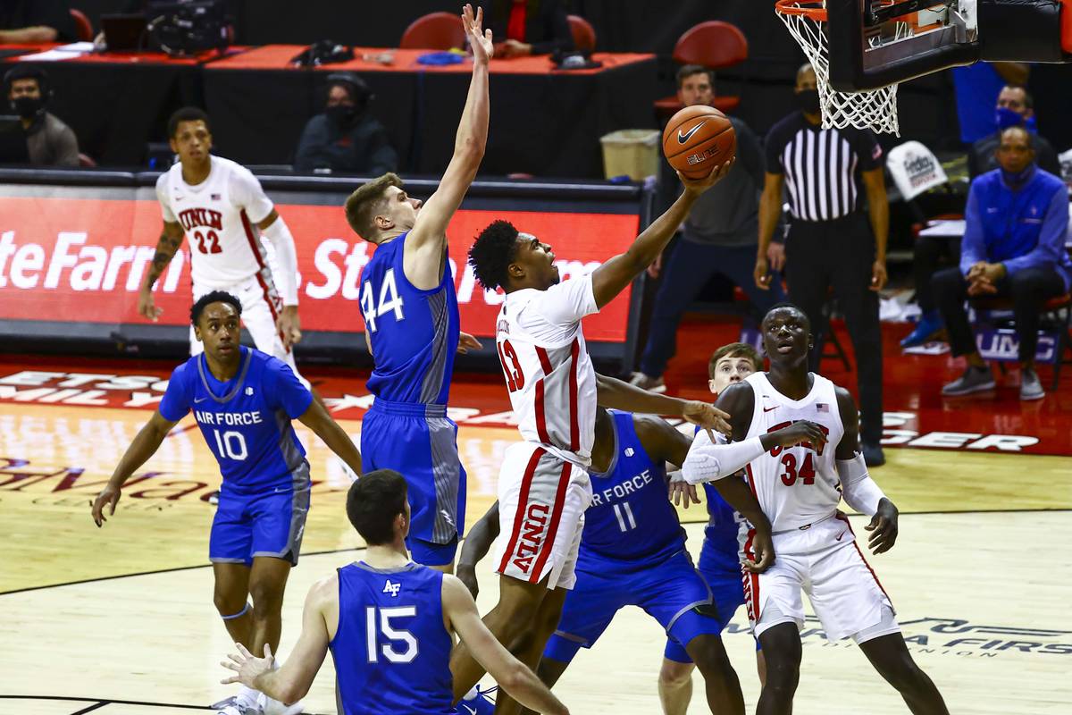 UNLV Rebels guard Bryce Hamilton (13) goes to the basket under pressure from Air Force Falcons ...