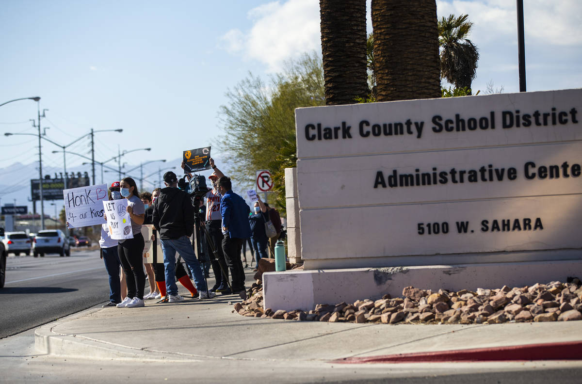 Student athletes and parents participate in a rally to urge school district officials to bring ...