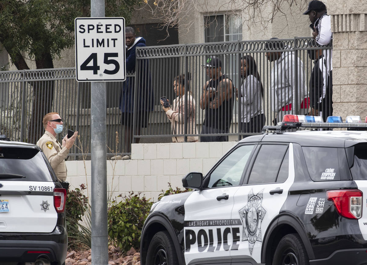 Milan apartment townhomes residents listen to a Metropolitan police officerÕs instructions ...